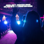 Leading Worship with Compassion | Worshipper with hands raised at a church worship service or other worship event.