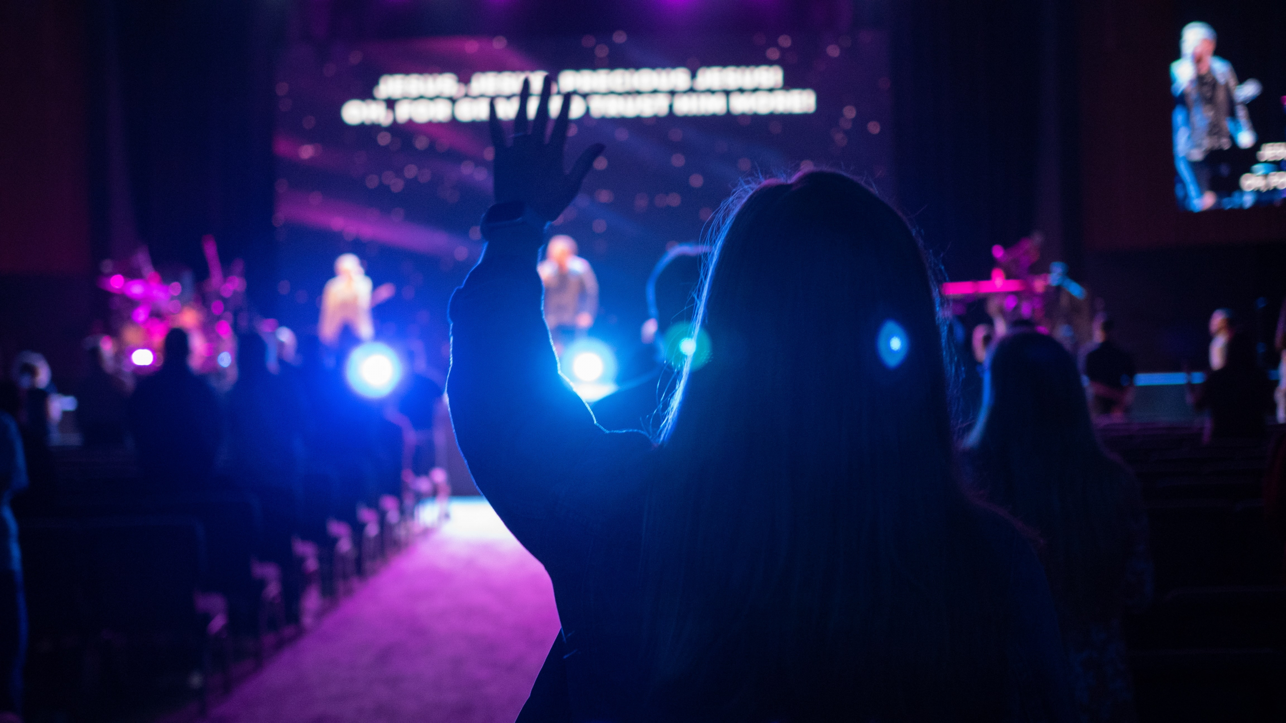 Leading Worship with Compassion | Worshipper with hands raised at a church worship service or other worship event.
