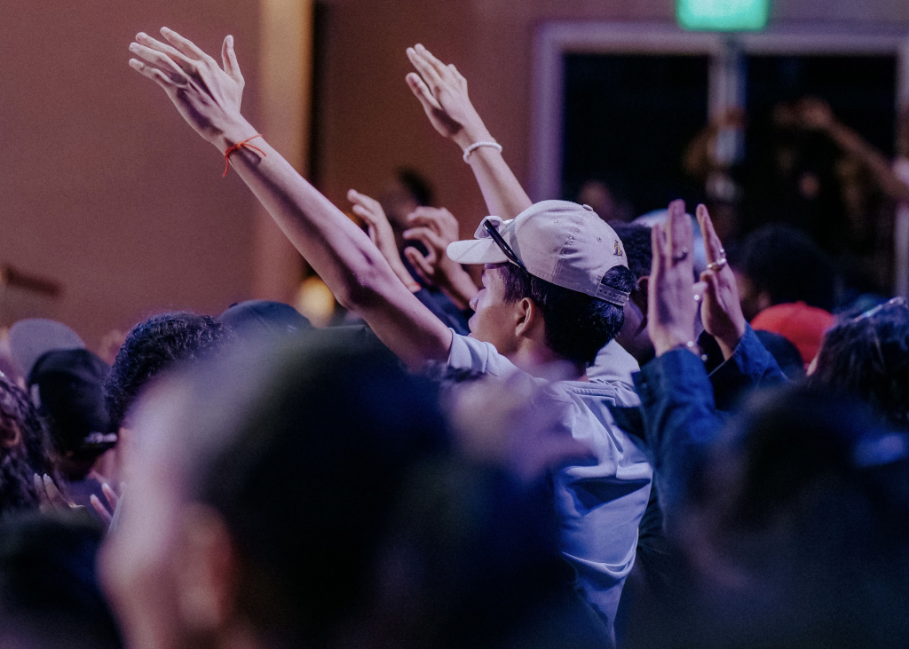 Leading Worship with Compassion | Worshipper with hands raised at a church worship service or other worship event.