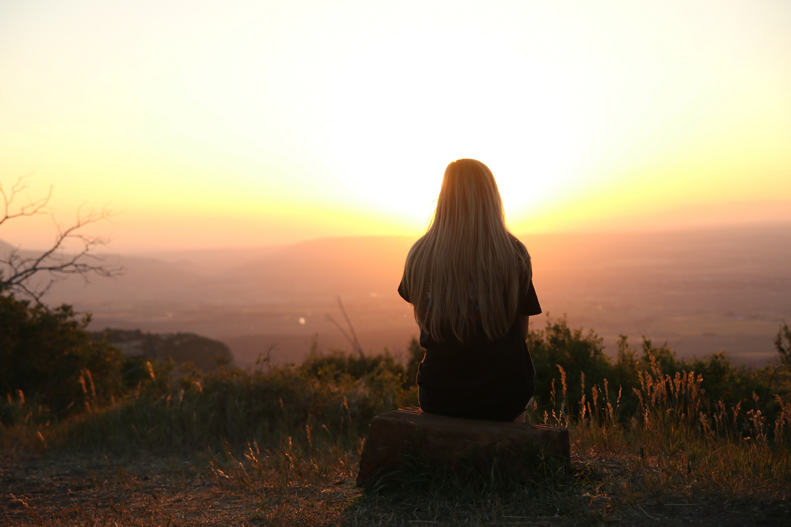 Photo of woman watching the sunset. By Pixabay. Used by permission on Pexels.